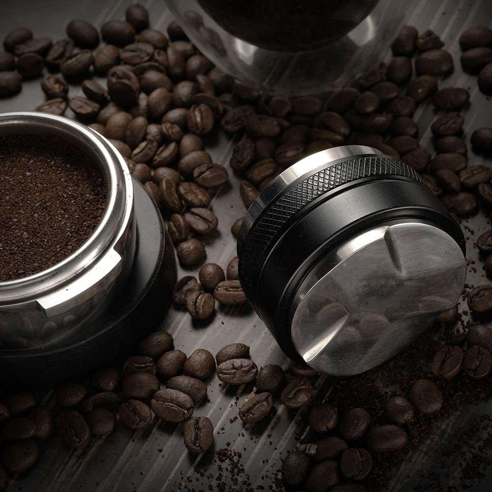53mm coffee distributor and tamper designed for Breville espresso machines, placed on a coffee station with freshly ground coffee and espresso shots in the background."